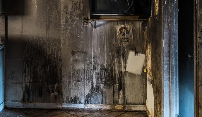 Smoke odor coming from a fire-damaged wall