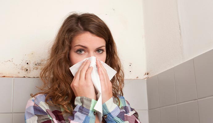 A young female's health is being affected by mold growth.